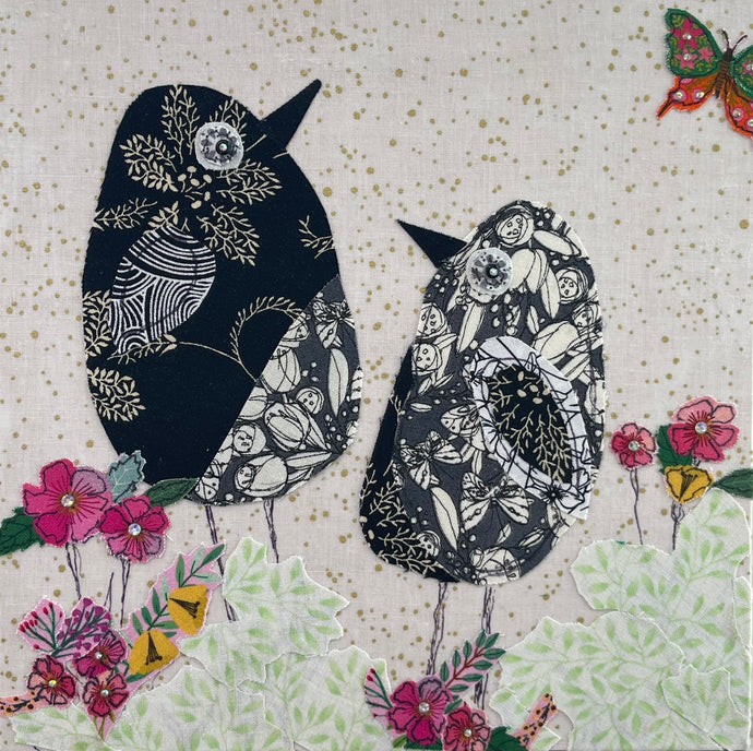 Two black birds with floral patterns on a textured beige background with flowers and butterflies.