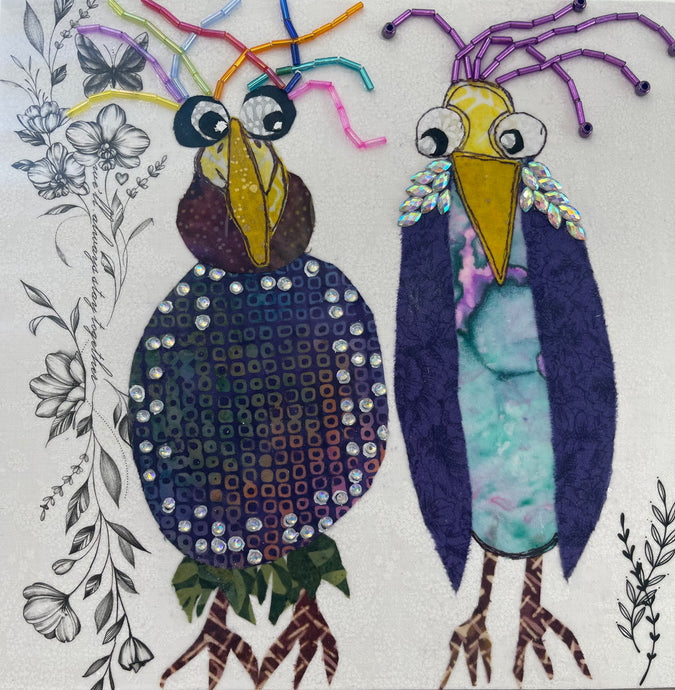 Whimsical bird artwork made with layered fabric and mixed media, featuring paired birds in warm neutral and muted blue tones with textured stitched looking details
