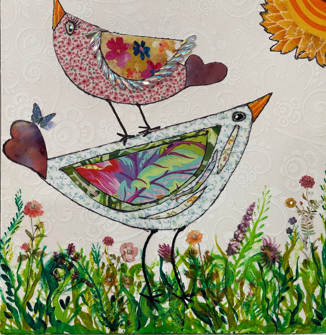 Whimsical bird artwork made with layered fabric and mixed media, featuring uplifting bird forms in soft neutral and warm tones in a grassy flower field