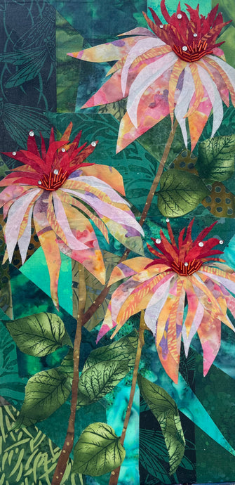 Original vertical botanical fabric art 16x8 inches, three cone flower blooms in blush pink peach orange and crimson batik fabric rising on slender stems, Czech glass bead and crystal embellished centers, deep forest green and teal batik background with leaf forms, on birch panel, part of the Floral and Botanical Collection