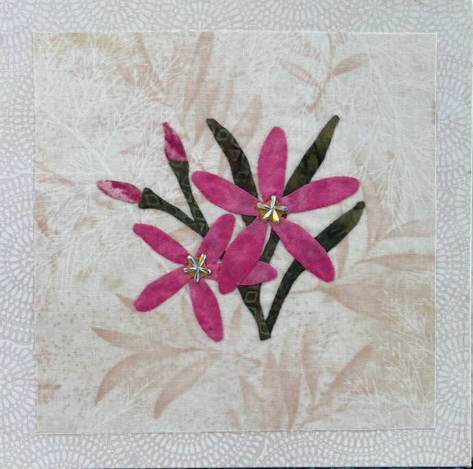 8 x 8 fabric collage artwork featuring pink flowers with crystal centers made from inherited textiles on neutral background