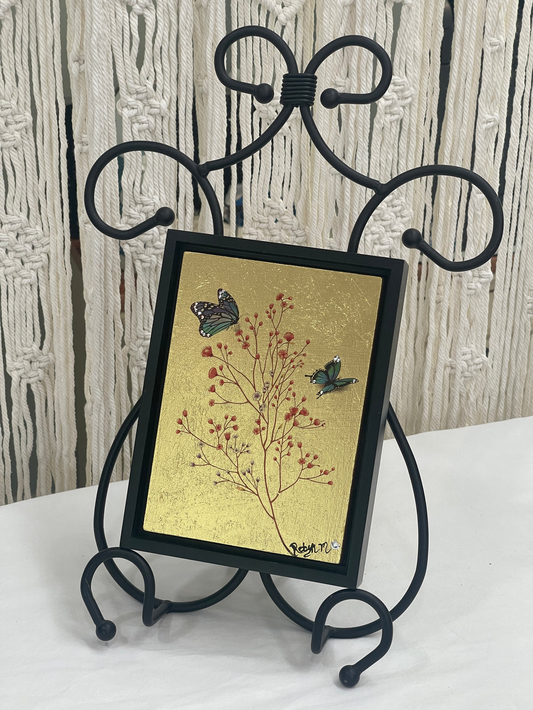 Original botanical mixed media artwork 8x8 inches, branch with coral and rose berries touched with Swarovski crystals, two teal and charcoal butterflies with crystal wing detail, gold leaf ground, birch panel, Golden Hour Collection, Robyn Moore Arts