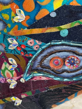 Close detail of a beaded eye-spot accent with Swarovski crystals along the fanned fabric wing on The Shape of Becoming by Robyn Moore Arts