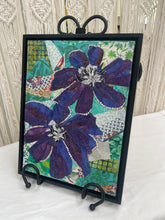 Original clematis flower fabric collage artwork 9x12 inches, two purple and blue batik blooms with Swarovski crystal vine trim, black and white beaded centers, teal patchwork background, birch panel, Floral and Botanical Collection, Robyn Moore Arts