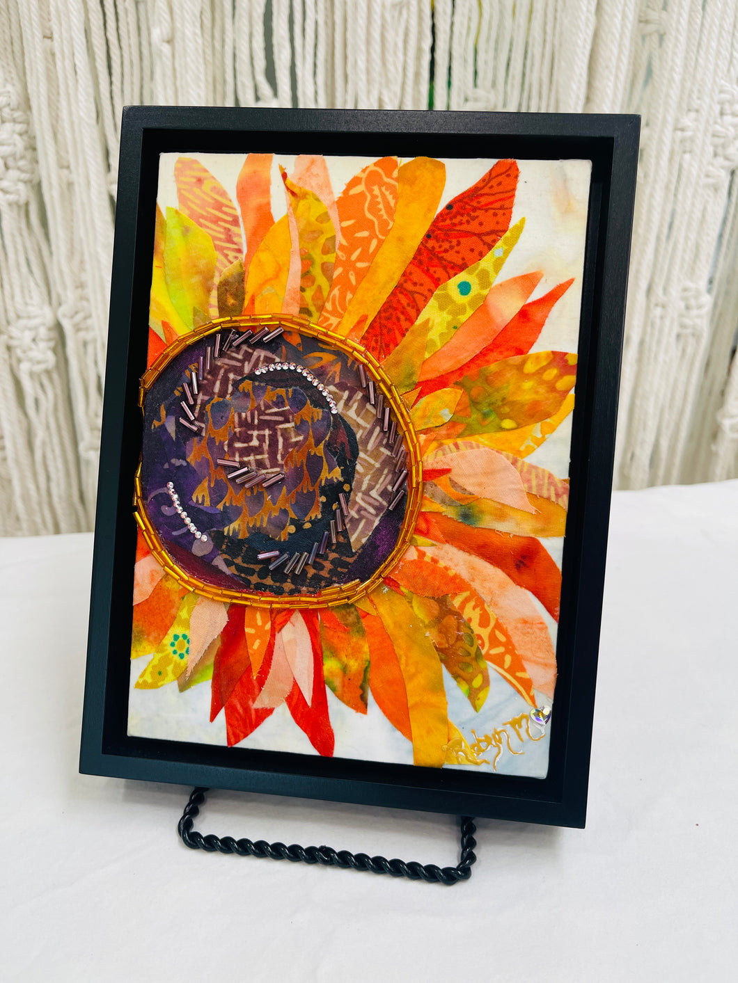 Sunflower wall art in fabric mixed media with layered petals, warm tones, and dimensional textile detail