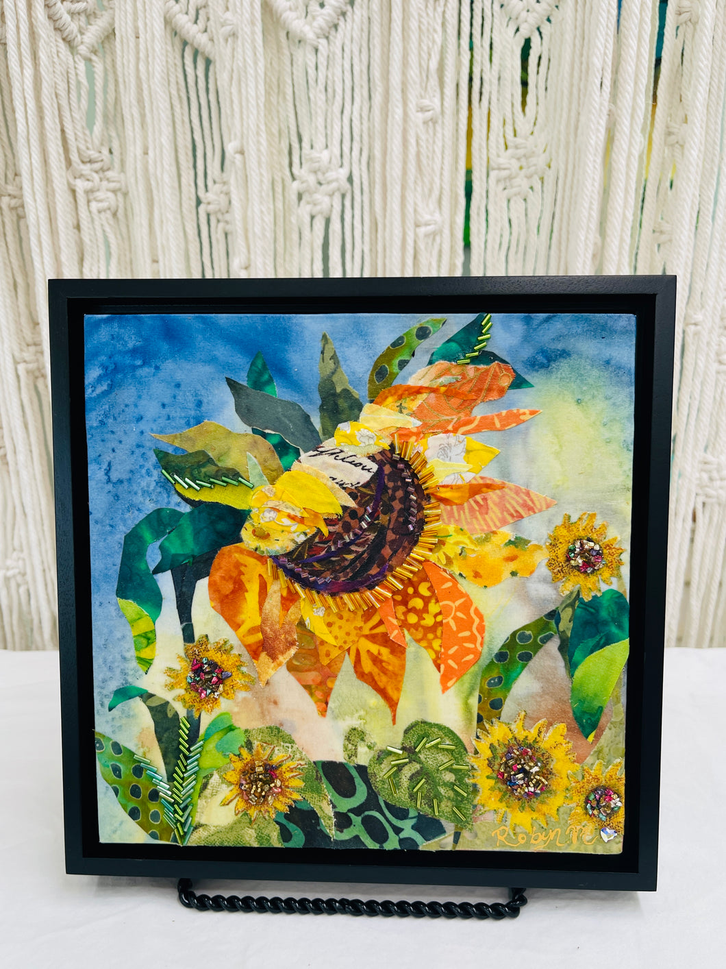 Sunflower-inspired floral wall art in fabric mixed media with layered petals, botanical design, and dimensional textile detail
