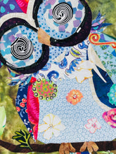 Close detail of Czech glass bead eye ring and spiral fabric eye center on original whimsical owl artwork Perfectly Odd by Robyn Moore Arts, showing precise dark bead outline surrounding black white spiral printed fabric eye above patchwork blue lavender fabric owl body