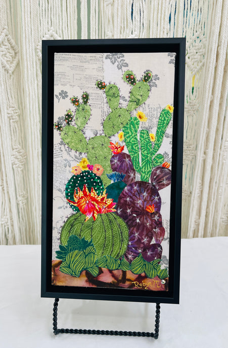 Original flowering cactus fabric artwork 6x12 inches, tall columnar green cacti dramatic dark spotted cactus with vivid pink orange blooms purple prickly pear Swarovski crystals ink pen spine detail, vintage toile botanical text background warm brown ground, birch panel, Floral Botanical Collection, Robyn Moore Arts