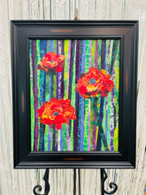Original all fabric floral collage artwork 20x16 inches, three bold poppy blooms in crimson burnt orange and golden yellow batik fabric with Swarovski crystals against vertical striped batik background in purple lavender green and yellow, presented in deep black frame, part of the Floral and Botanical Collection by Robyn Moore Arts