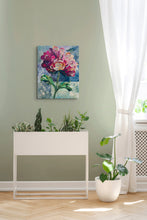 Original fabric peony artwork Where Light Lands by Robyn Moore Arts displayed on a sage green wall above a white modern planter with indoor plants in a bright botanical inspired living space