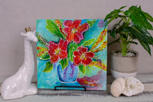 Bright red and orange flowers in a blue vase