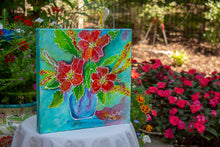 Bright red and orange flowers in a blue vase